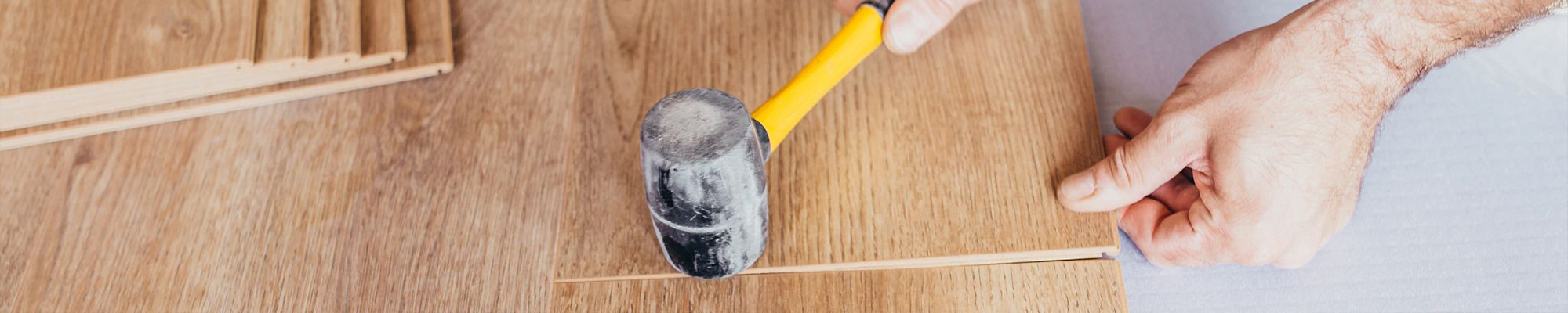 installing hardwood flooring with hammer - Hughes Hardwoods, CA